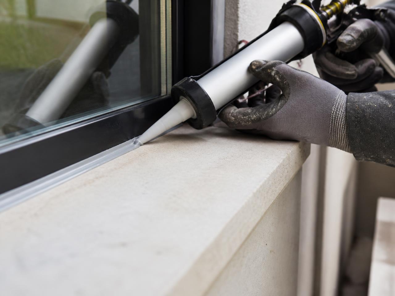 Fresh sealant bead tooled around an exterior window frame
