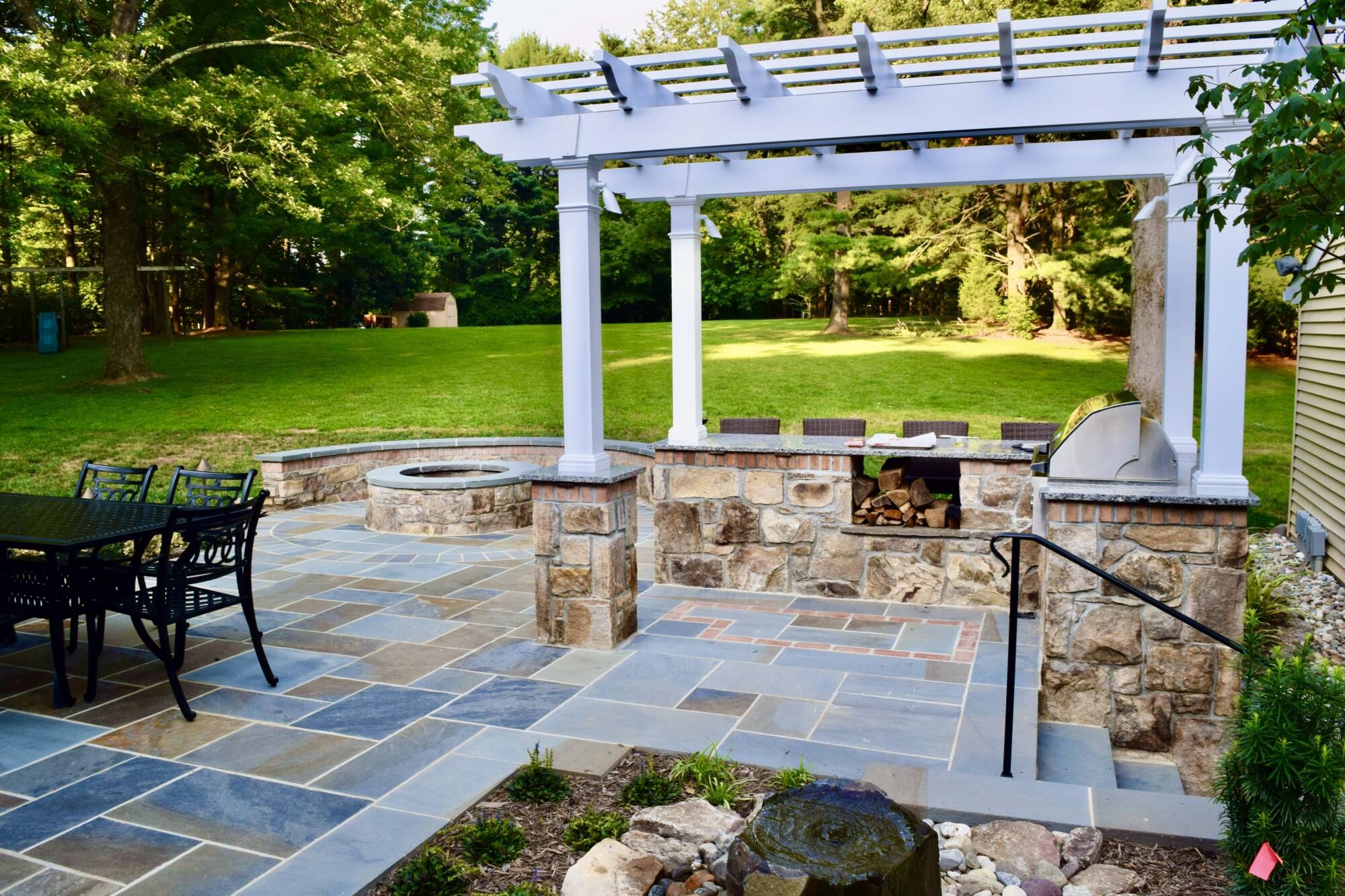 Stone seat wall and column built alongside a new patio
