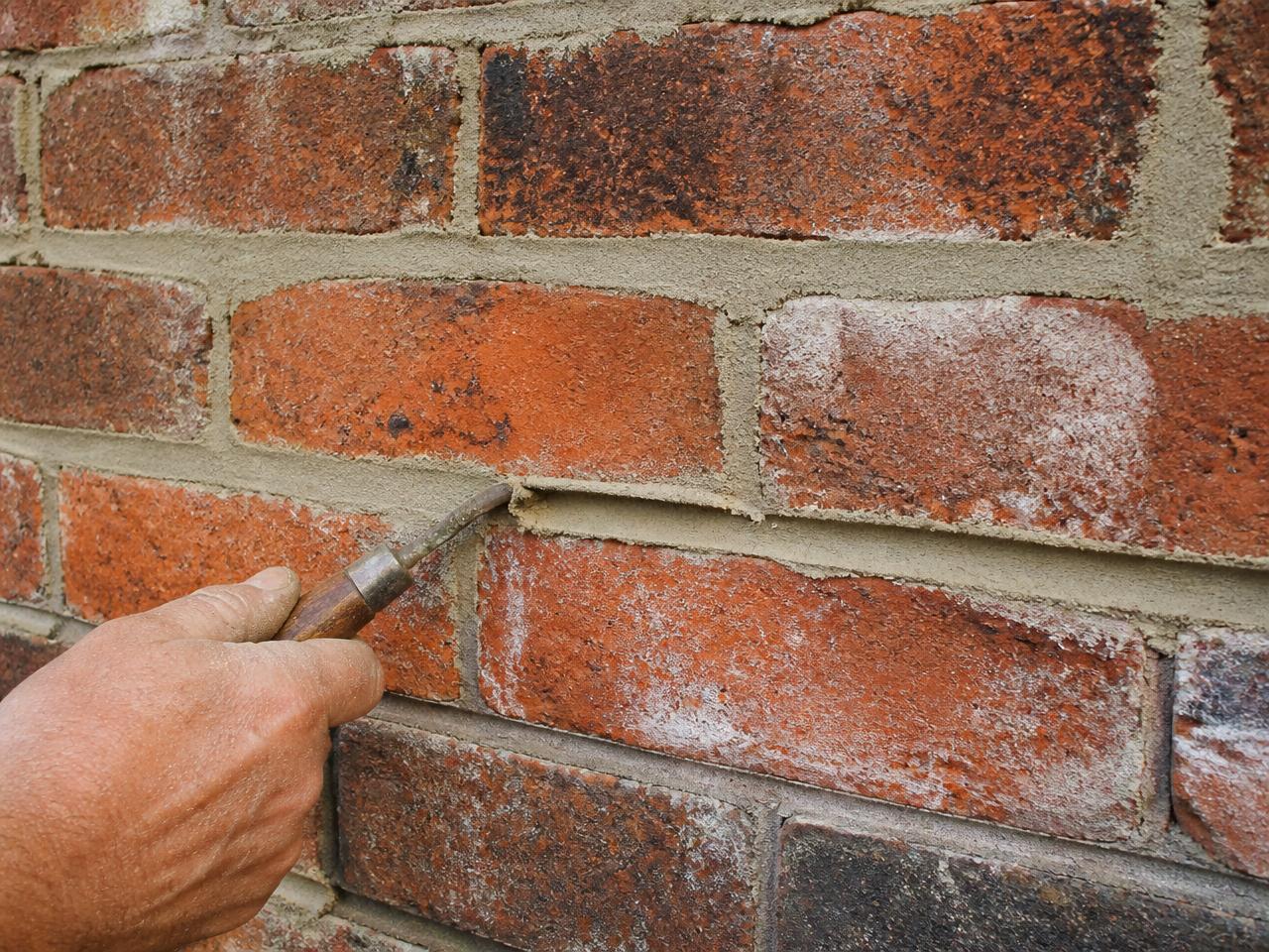 Masonry wall sealed after repointing to prevent water intrusion